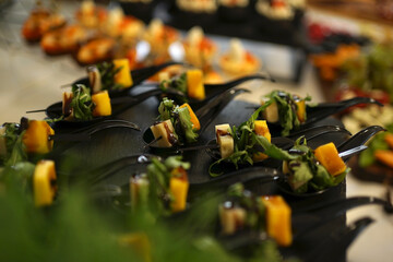 A cold appetizer made of cheese and greens, covered with sauce. Decoration of the buffet table.