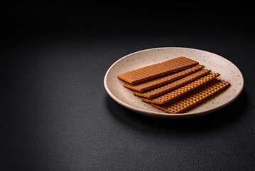 Delicious sweet crispy rectangular waffles on a ceramic plate