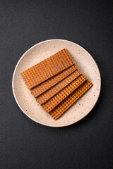 Delicious sweet crispy rectangular waffles on a ceramic plate