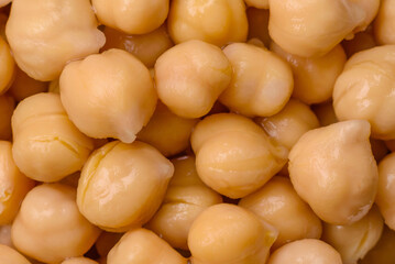 Delicious canned chickpeas in a ceramic plate on a dark concrete background