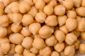 Delicious canned chickpeas in a ceramic plate on a dark concrete background