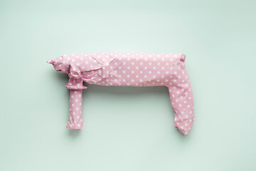 Creative men's gift concept. Electric drill wrapped in pink polka dot gift paper on a blue pastel...