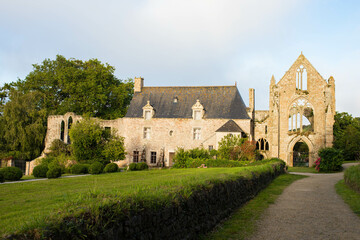 Fototapeta na wymiar The main facade and alleyway of Beauport Abbey, a roofless gothic building located in Paimpol, Cotes d'Armor, Brittany, France. August 2023, sunset 