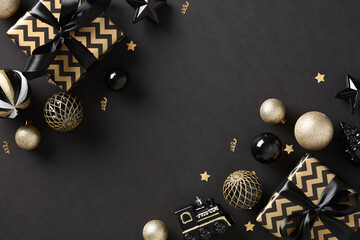 Merry Christmas black background with striped gift boxes and stylish gold and black Xmas balls...