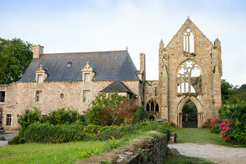 Fototapeta na wymiar The main facade of Beauport Abbey, a roofless gothic building located in Paimpol, Cotes d'Armor, Brittany, France. August 2023, sunset view.