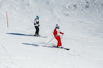Learning ski. Skiing woman skier going downhill against snow on ski trail slope piste in winter....