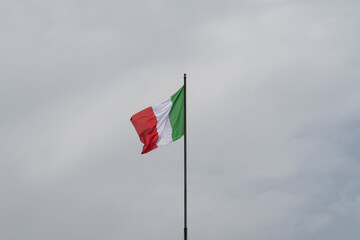 Italy flag under sky background. Travel wallpaper