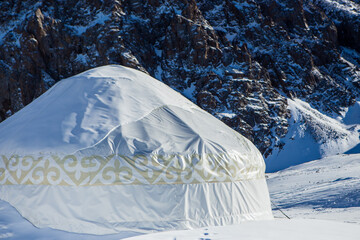 Kazakh yurt in the mountains near Almaty in the snow in winter. House of nomadic peoples in the...
