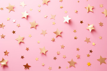 golden star confetti on a pastel pink backgroung, festive Christmas backdrop