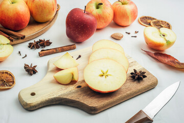Fresh ripe apples on cutting board on white table background. . Autumn harvest, ingredients for apple pie concept. Top view