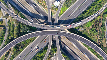 Aerial drone photo of multilevel bridge highway road interchange
passing near urban residential...