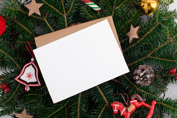 Christmas 5x7 card mockup template with envelop on natural fir branch background. Design element...
