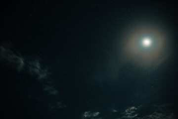 Fototapeta na wymiar Moon shine on night sky with stars and clouds