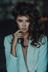 Portrait of young sexy brunette with curly hair