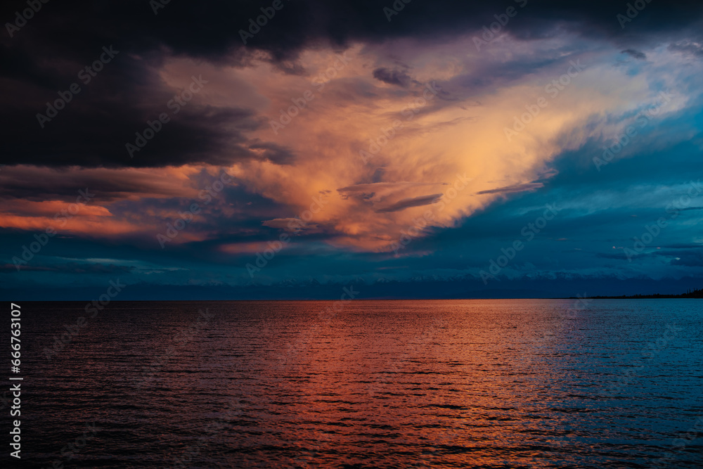 Poster Dramatic landscape of Issyk-Kul lake with mountains and clouds at sunset, Kyrgyzstan