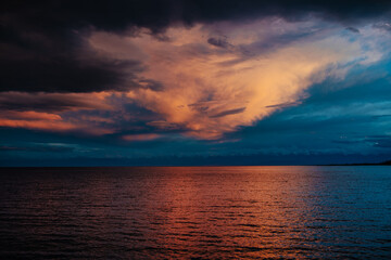 Dramatic landscape of Issyk-Kul lake with mountains and clouds at sunset, Kyrgyzstan