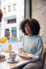 African-american woman having breakfast in a cafeteria