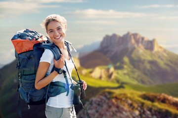 Fototapeta na wymiar Happy young female with backpack on top mount