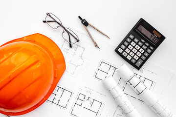 Construction drawing blueprints with helmet, top view. house designing and architect plan concept