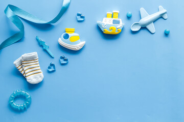 Blue birthday party for baby boy with accessories and gift box, top view