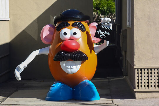 Colorful giant toy statue of Mr. Potato Head on a sunny outdoor day.