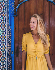 Gleeful woman near ornamental entrance