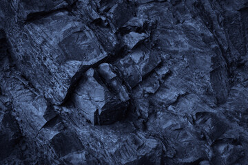 Dark blue rock basalt texture. Rough mountain surface. Close-up. Stone background for design. 3D shape. Cracked collapse broken  crumbled. Fantasy. Like cold frost ice.