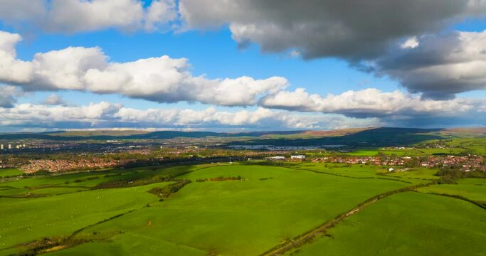 Hyper-Lapse video of Tandle Hill landscape showing green fields and sheep grazing with fast moving clouds. Beautiful Vista