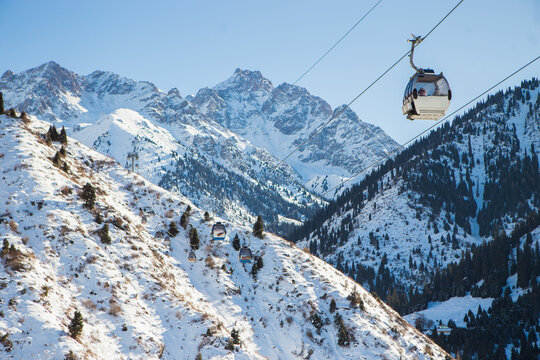Cableway with funicular in the winter mountains at Shymbulak mountain resort in Almaty, Kazakhstan.