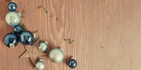 Wide Christmas template bright blue toy balls, stars and baubles as a border in the corner. New Year 2024 theme. Copy space for text