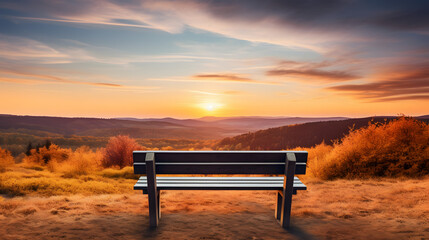 A wooden bench overlooking a vast valley the landscape bathed in the golden hues of sunset. - obrazy, fototapety, plakaty