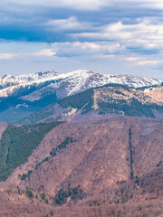 Scenic view from Baiului Mountains with the snowy peaks of Bucegi Mountains. Carpathians in Romania.