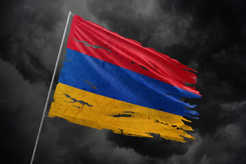 Armenia torn flag on dark sky background.