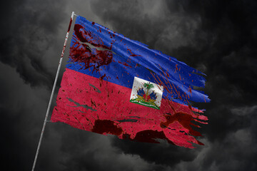 Haiti torn flag on dark sky background with blood stains.