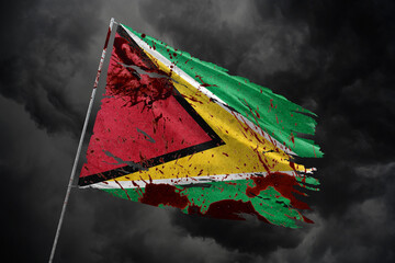 Guyana torn flag on dark sky background with blood stains.