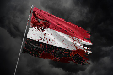 Yemen torn flag on dark sky background with blood stains.