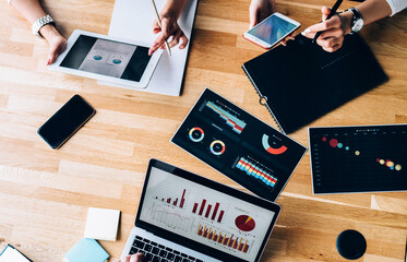 People working with electronic devices and papers