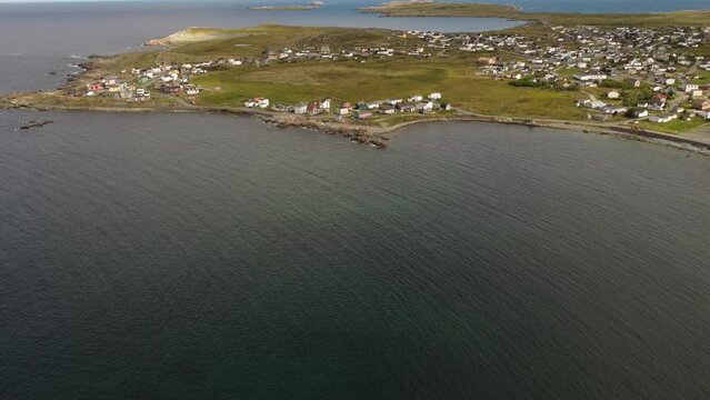 Bonavista Newfoundland high aerial revealing shot overlooking the Atlantic Ocean and distant Cape Bonavista Canada.
