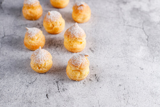 Homemade profiteroles with powdered sugar.