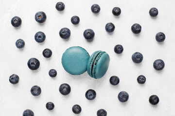 Colorful french dessert macarons with fresh fruits and nuts.