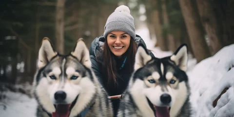 Fotobehang Young woman musher behind sleigh at sled husky dog race on snow in winter forest © Viks_jin