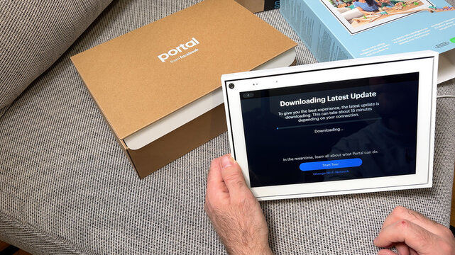 Paris, France - Apr 8, 2022: uring the unboxing process, a Facebook Portal device is shown downloading the latest update, ensuring that it's up-to-date and ready for use