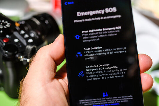 London, UK - Sep 28, 2023: unboxing of the latest iPhone 15 Pro, a male hand holds the smartphone displaying the text Crash detection and emergency SOS via satellite.