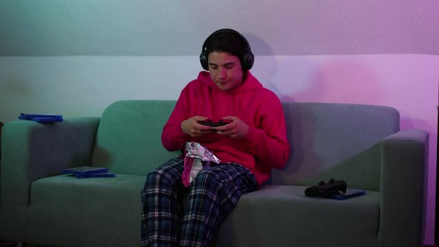handsome guy plays computer games on console.night game in ps5.young gamer