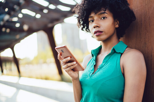  African American hipster girl using mobile phone app