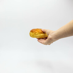 hands holding white common champignon mushrooms on white background