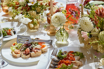 Graceful chambers table setting, arranged flowers with natural light. Cozy aesthetics holidays table setup.