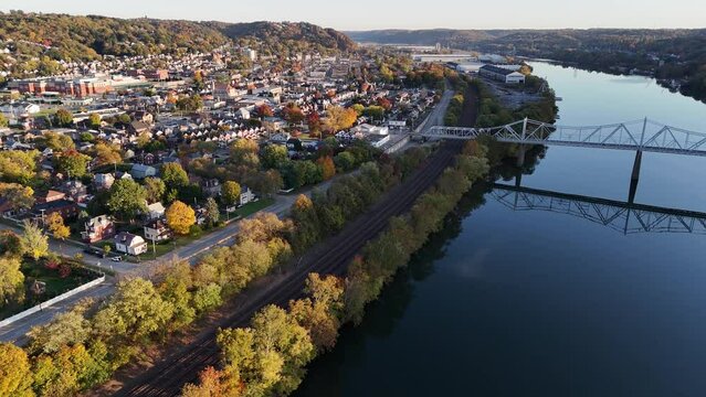 A high angle dusk aerial establishing shot view of a small New England river town. Pittsburgh suburbs.  	