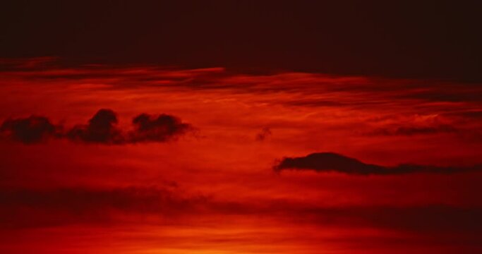Big sun rising through clouds, dramatic red sky time lapse, close up beautiful nature background timelapse