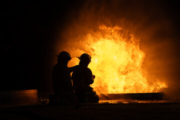 Firefighters in action to fight the huge Fire burning, Putting out the flames,